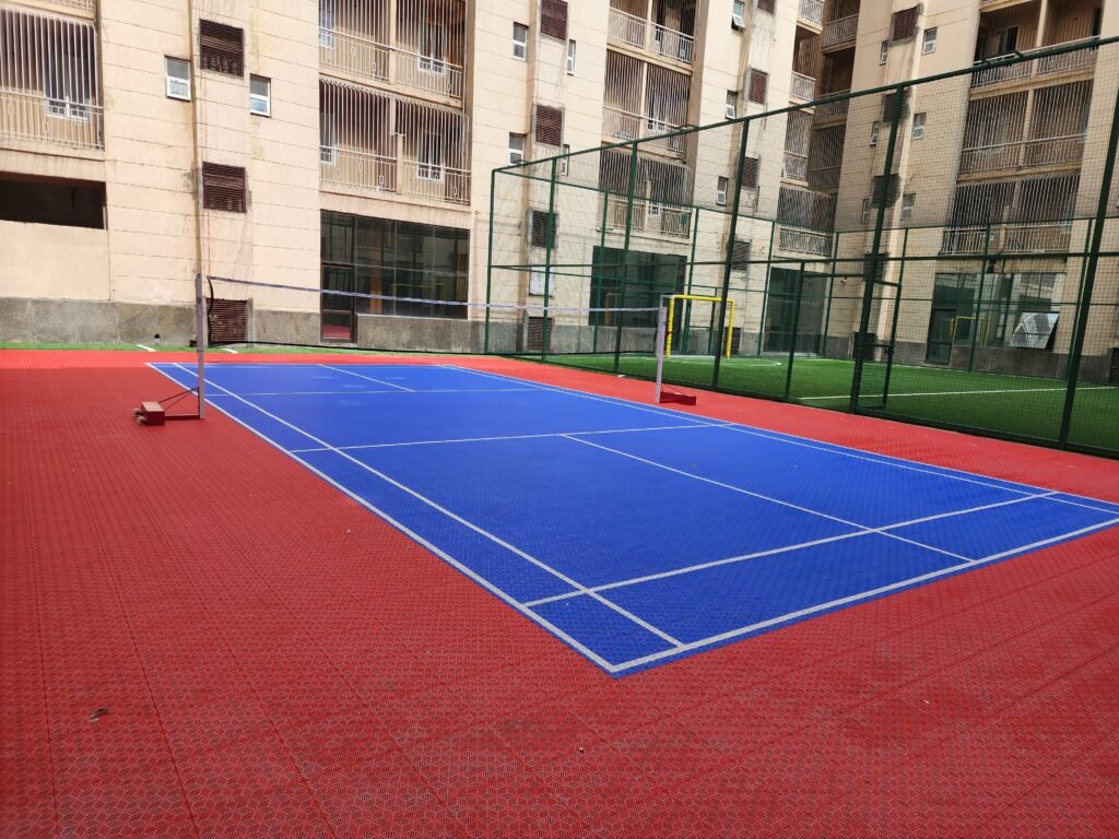 Outdoor badminton court with acrylic flooring and net installation