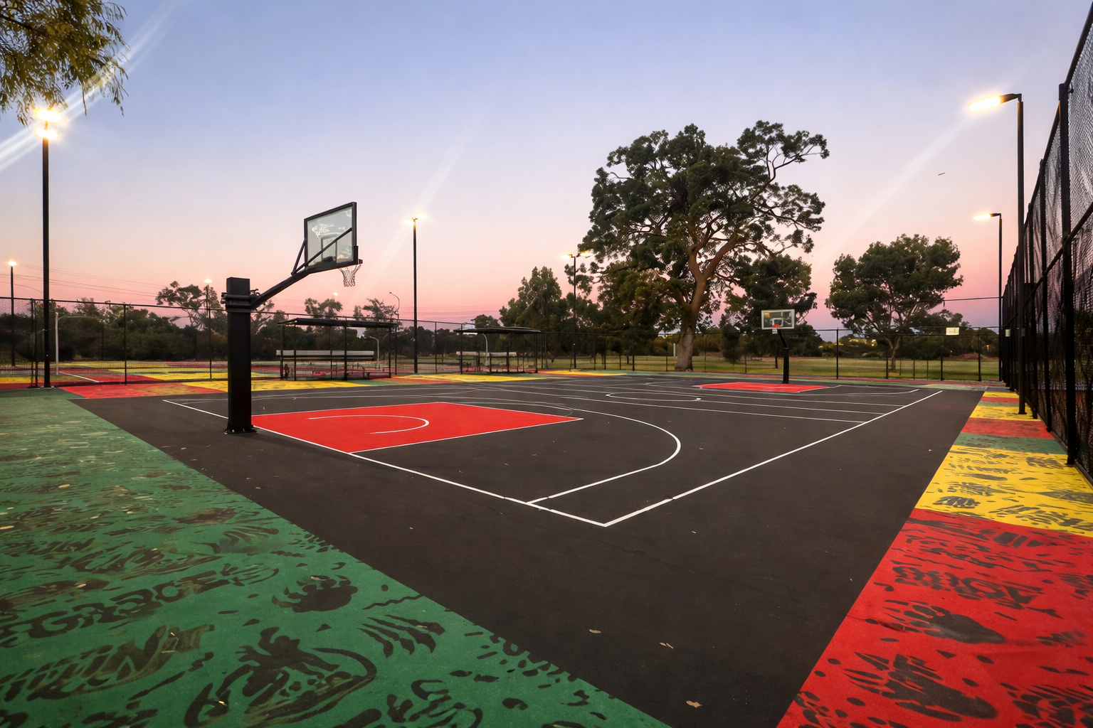 Modern outdoor basketball court with blue and red synthetic flooring