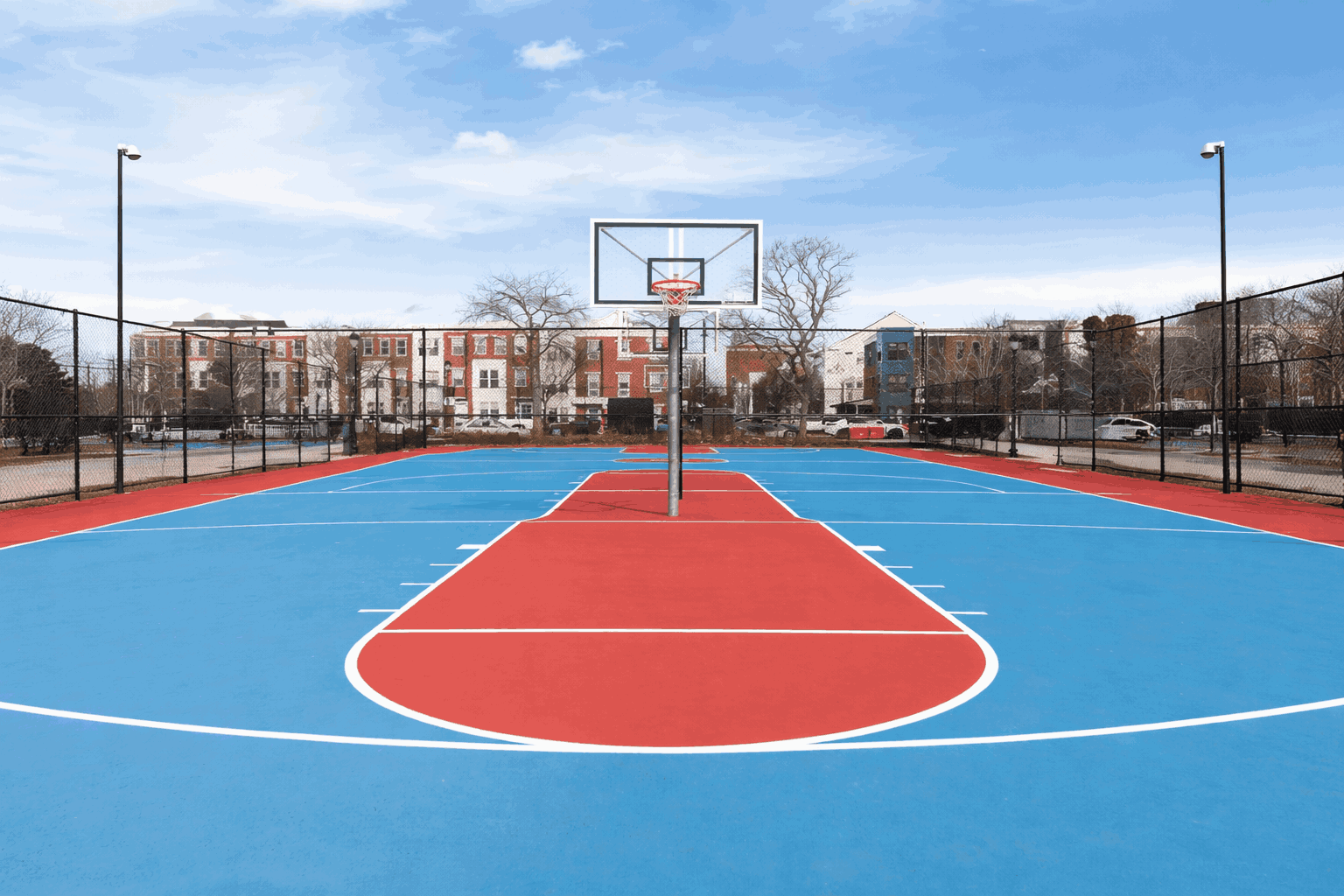 Professional outdoor basketball court with acrylic surface and lighting