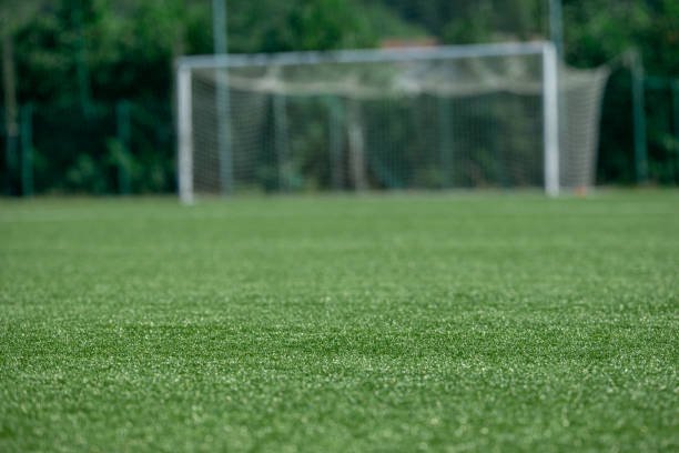 Outdoor football turf ground with artificial grass and standard field markings