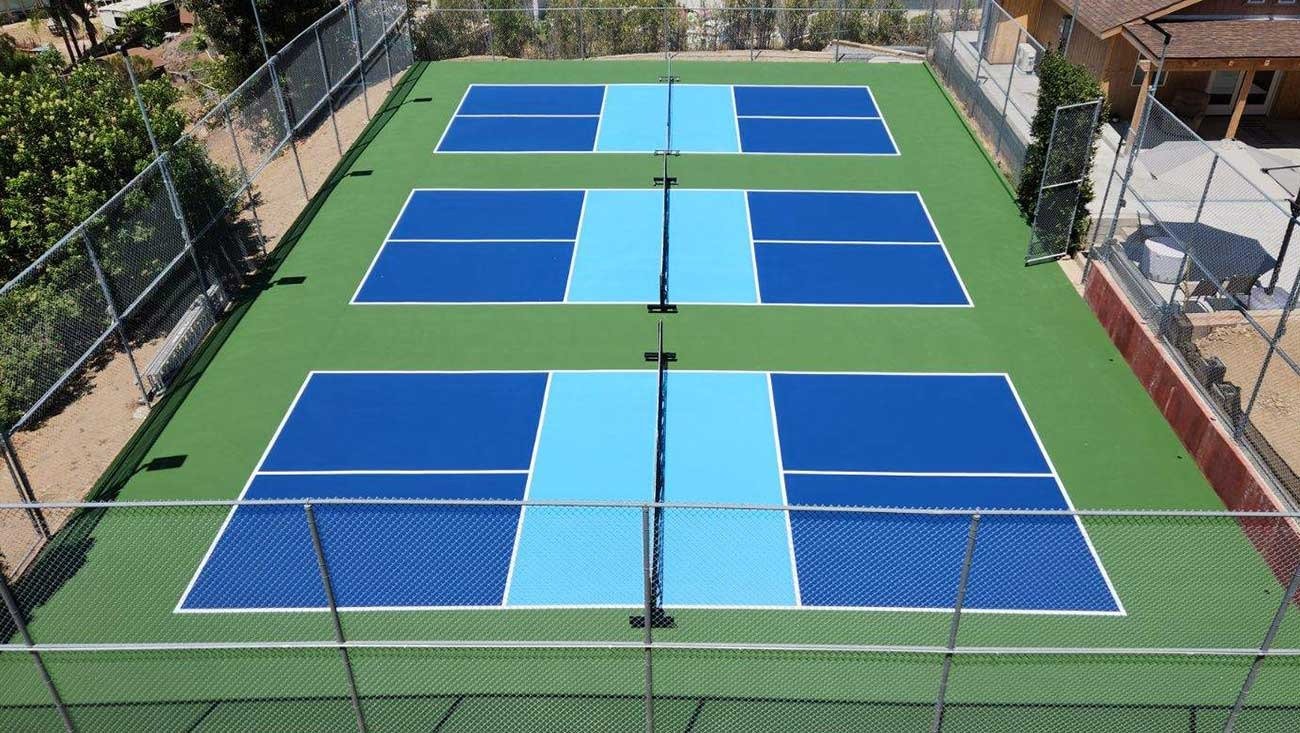 Outdoor pickleball courts with acrylic sports flooring and fencing