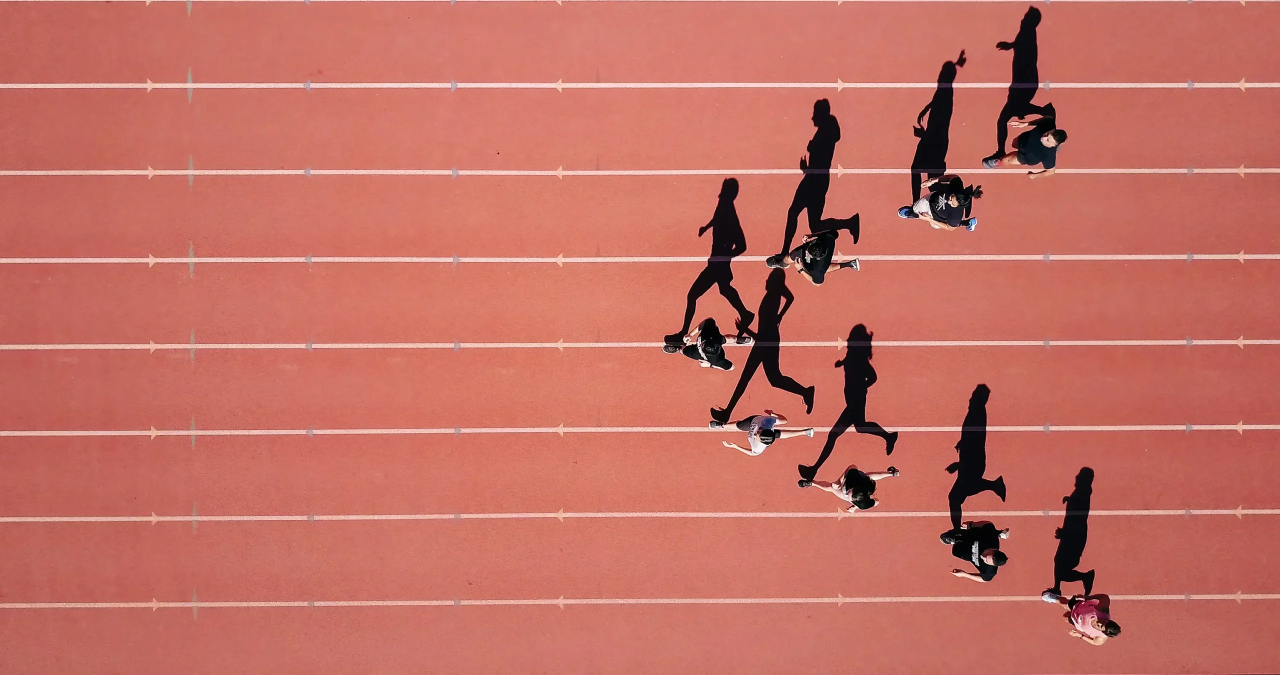 Athletic running track with multiple runners on a professional synthetic jogging and athletics track