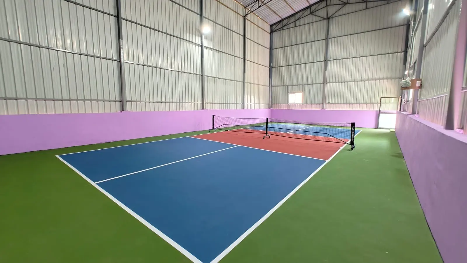 Indoor pickleball court with acrylic sports flooring and professional court markings