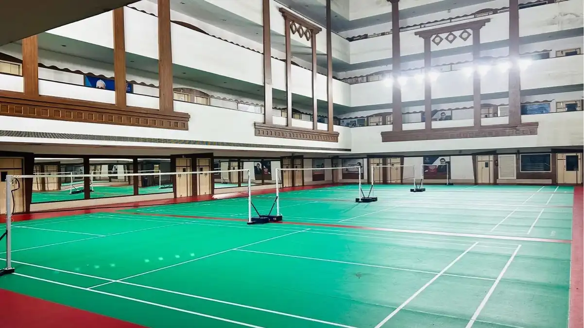 Indoor badminton court with synthetic sports flooring and professional court markings