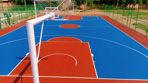 Outdoor basketball court with acrylic sports flooring and professional hoop setup