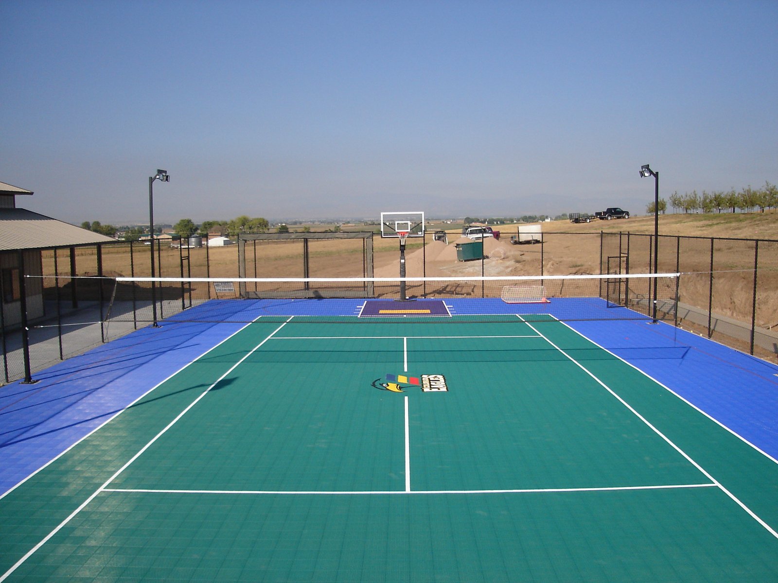 Outdoor volleyball court with acrylic sports flooring and professional net setup