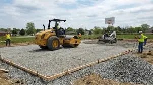 Base preparation for sports ground construction with soil leveling and compaction for turf installation