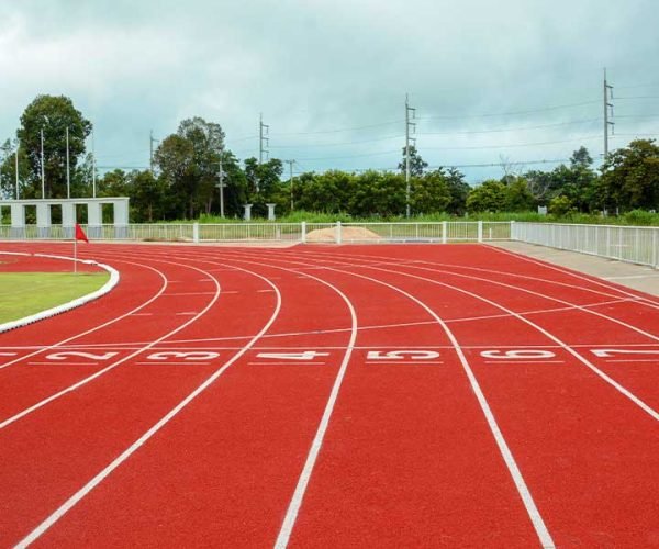 PU sandwich system athletic running track with red synthetic surface in a professional sports stadium