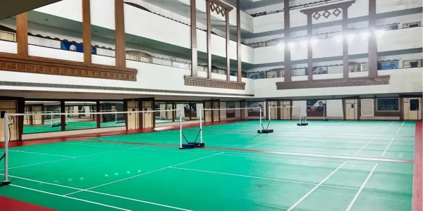 Indoor badminton court with synthetic sports flooring and professional court markings