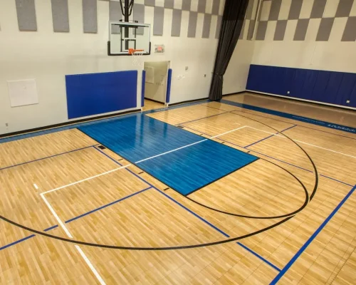 Indoor wooden baseball court flooring with polished surface and sports markings