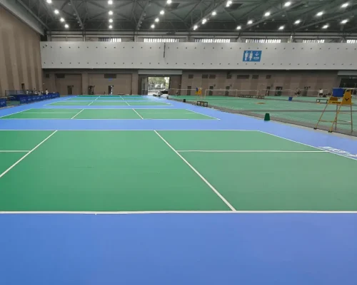 Indoor pickleball courts with synthetic flooring and multiple court layouts
