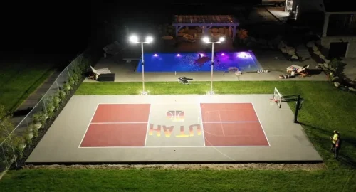 Professional stadium lighting installed for outdoor basketball court by YNextGen Sports Infra at night