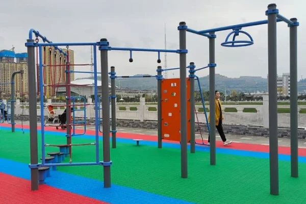 Outdoor gym construction with modern street workout equipment installed for fitness training in parks, schools, and public spaces.