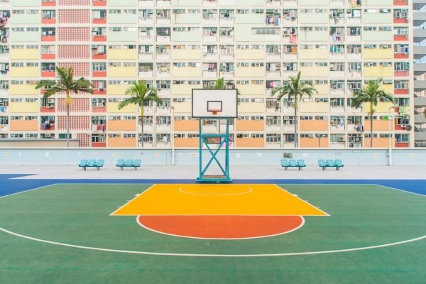 Outdoor synthetic basketball court with colorful surface and hoop setup