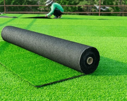 Artificial grass turf roll installation on sports field